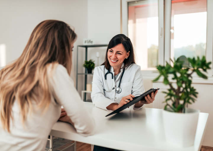 Female doctor explaining diagnosis to her young patient.